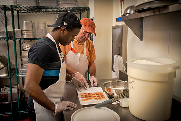 Shaquille Brown in the Community Kitchen with Scott Roubeck